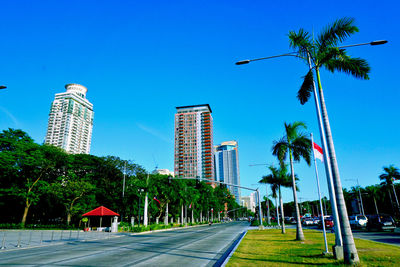 Low angle view of buildings against clear blue sky