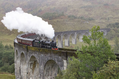 Steam train on railway bridge