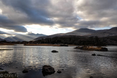 Scenic view of lake and mountains against sky