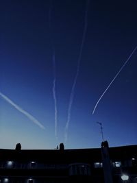 Low angle view of illuminated lights against blue sky