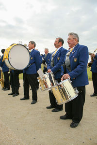 Group of people in traditional clothing against sky