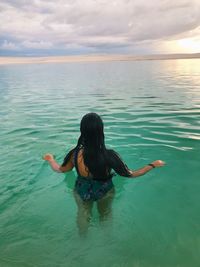 Rear view of a woman swimming in the lençóis maranhenses nacional park 