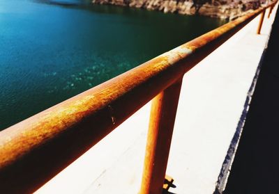 Close-up of railing by water