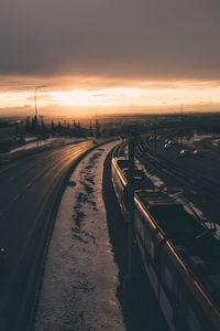 High angle view of railroad tracks against sky during sunset