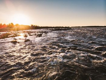 Scenic view of sea against clear sky during sunset