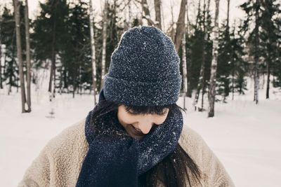Portrait of teenage girl covering face in winter
