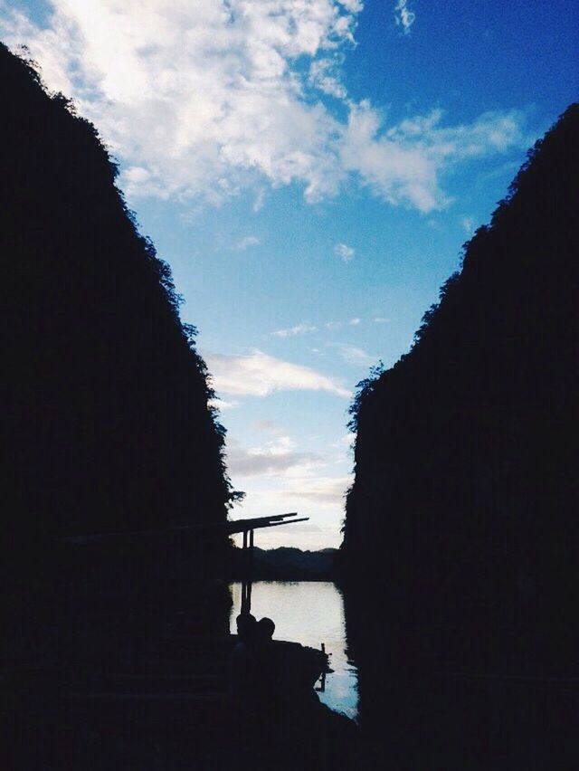 silhouette, sky, cloud - sky, built structure, architecture, low angle view, building exterior, cloud, dusk, nature, cloudy, tranquility, beauty in nature, outdoors, tranquil scene, scenics, no people, outline, sunset, mountain