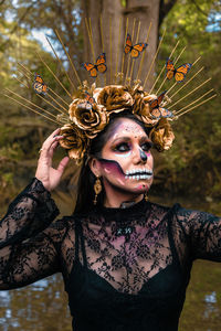 Portrait of young woman wearing day of the deas makeup in mexico