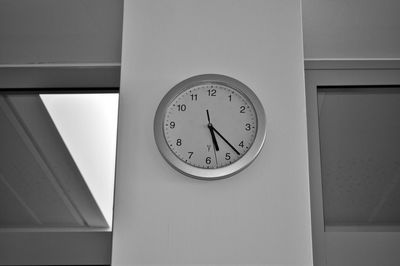 Low angle view of clock on wall