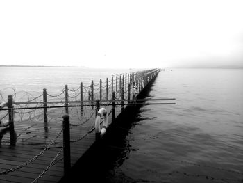 Pier over sea against clear sky