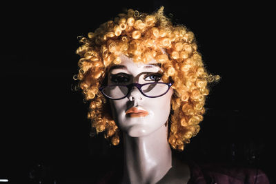 Portrait of mannequin against black background