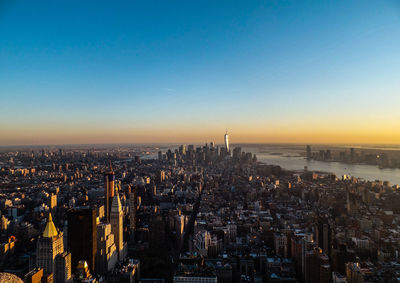 Illuminated cityscape against clear sky