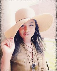 Portrait of young woman in hat