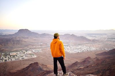 Rear view of man standing on mountain