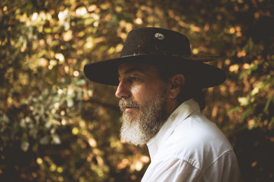 Thoughtful bearded man wearing hat looking away