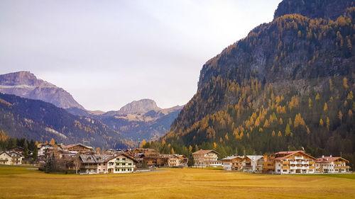 Scenic view of houses and mountains against sky