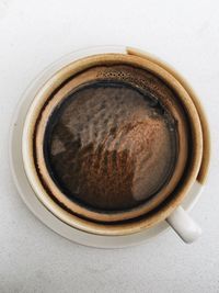 High angle view of coffee cup over white background