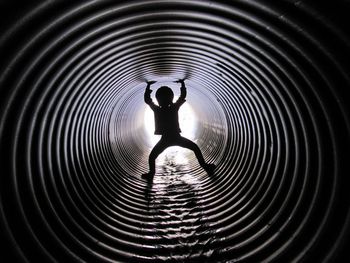 Full length of child in tunnel