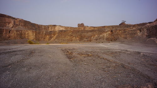 Scenic view of arid landscape against clear sky