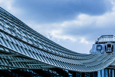 High section of built structures against clouds