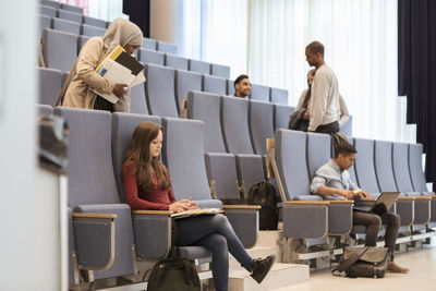 Young students studying in lecture hall at university