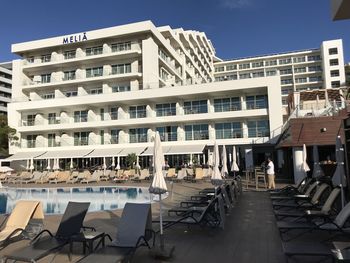 Empty chairs and tables against clear sky