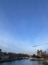 Bridge over river against blue sky