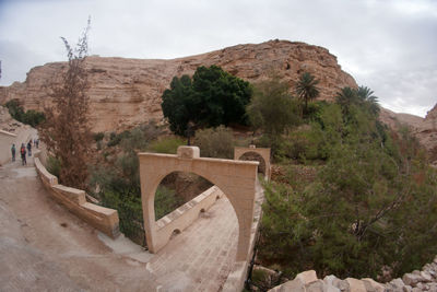 Built structure on mountain against cloudy sky