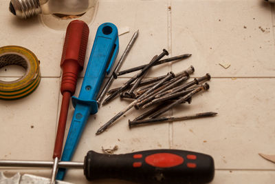 Flat renovation, master of his tools scattered all over the table, nails and screwdrivers