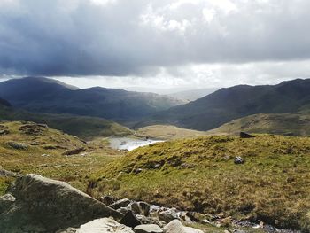 Scenic view of mountains against cloudy sky