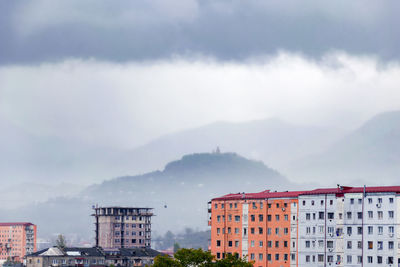 Buildings in city against sky