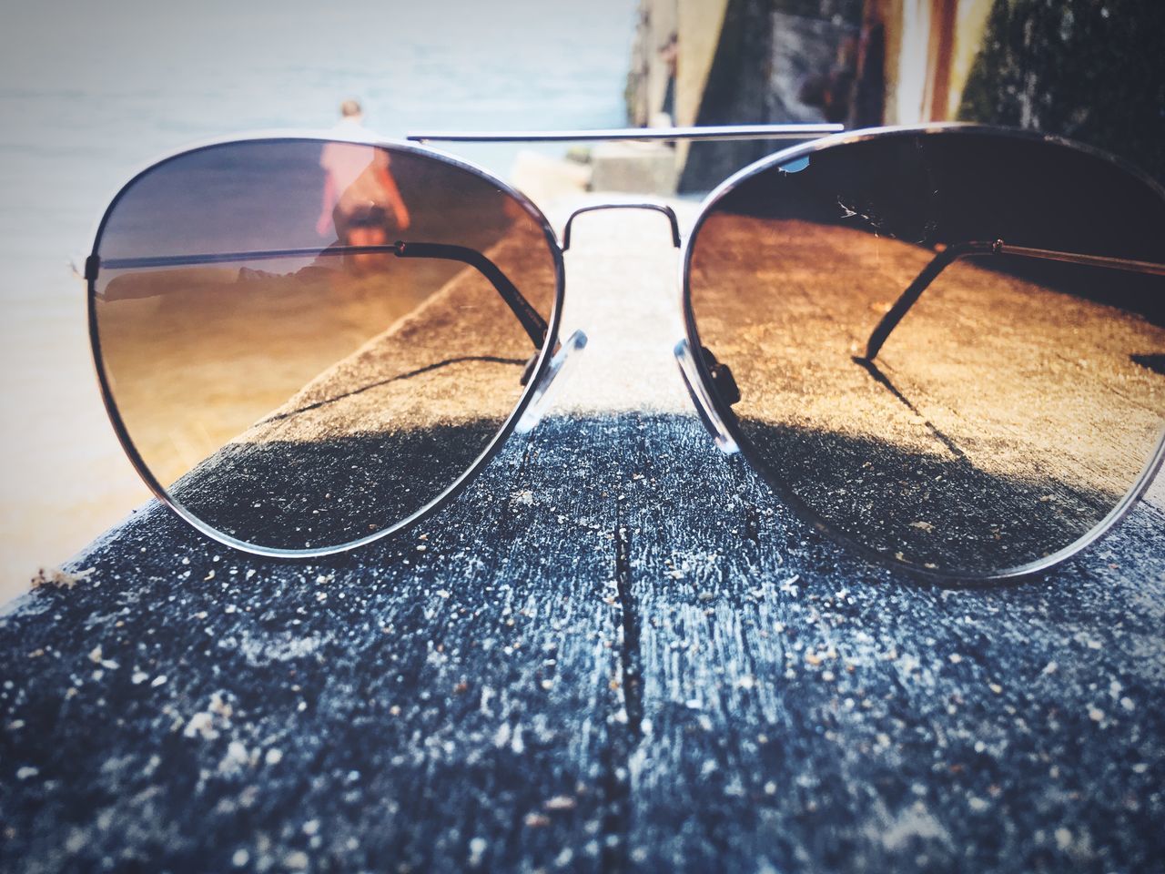 glasses, sunglasses, reflection, glass - material, fashion, personal accessory, close-up, day, selective focus, transparent, still life, eyeglasses, no people, table, outdoors, security, protection, wood - material, nature, focus on foreground, surface level, eyewear