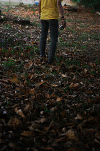 Low section of person standing on field during autumn