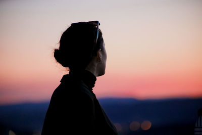 Rear view of woman looking at sunset