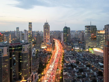 High angle view of illuminated city buildings against sky