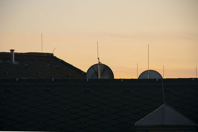 Houses against sky during sunset