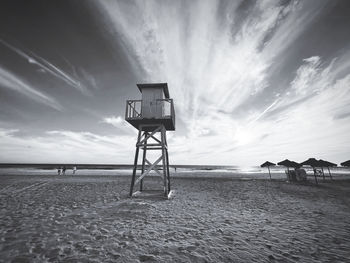 Lifeguard hut on beach against sky