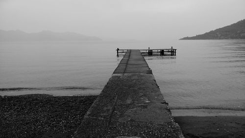 Pier over sea against clear sky