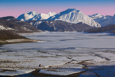 Amazing sunset over frozen lake of campotosto in abruzzo