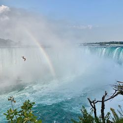 Scenic view of waterfall against sky