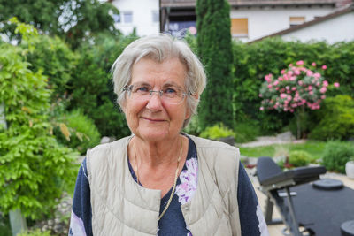 Portrait of mid adult woman against plants