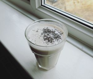 Close-up of smoothie by window