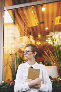 Portrait of young man standing in store