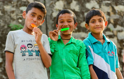 Portrait of smiling boy holding camera