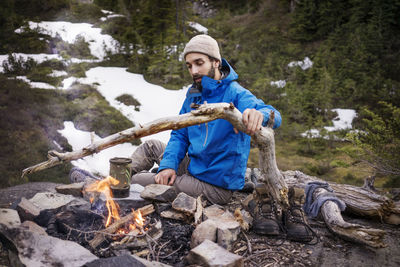 Man burning campfire