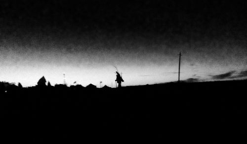 Silhouette person standing on landscape