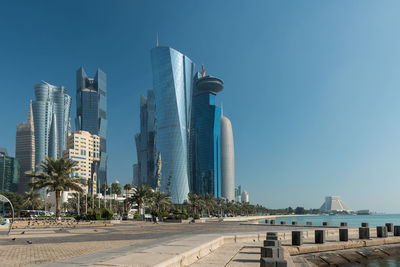 View of skyscrapers against blue sky