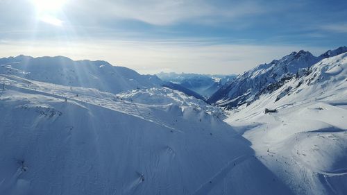 Scenic view of snow covered mountains against sky