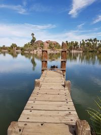 Pier over lake against sky