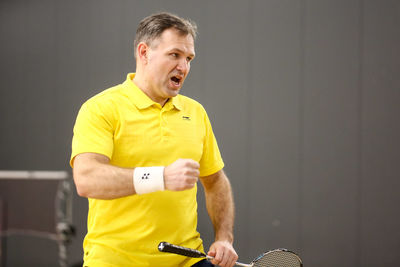 Full length of man holding yellow camera